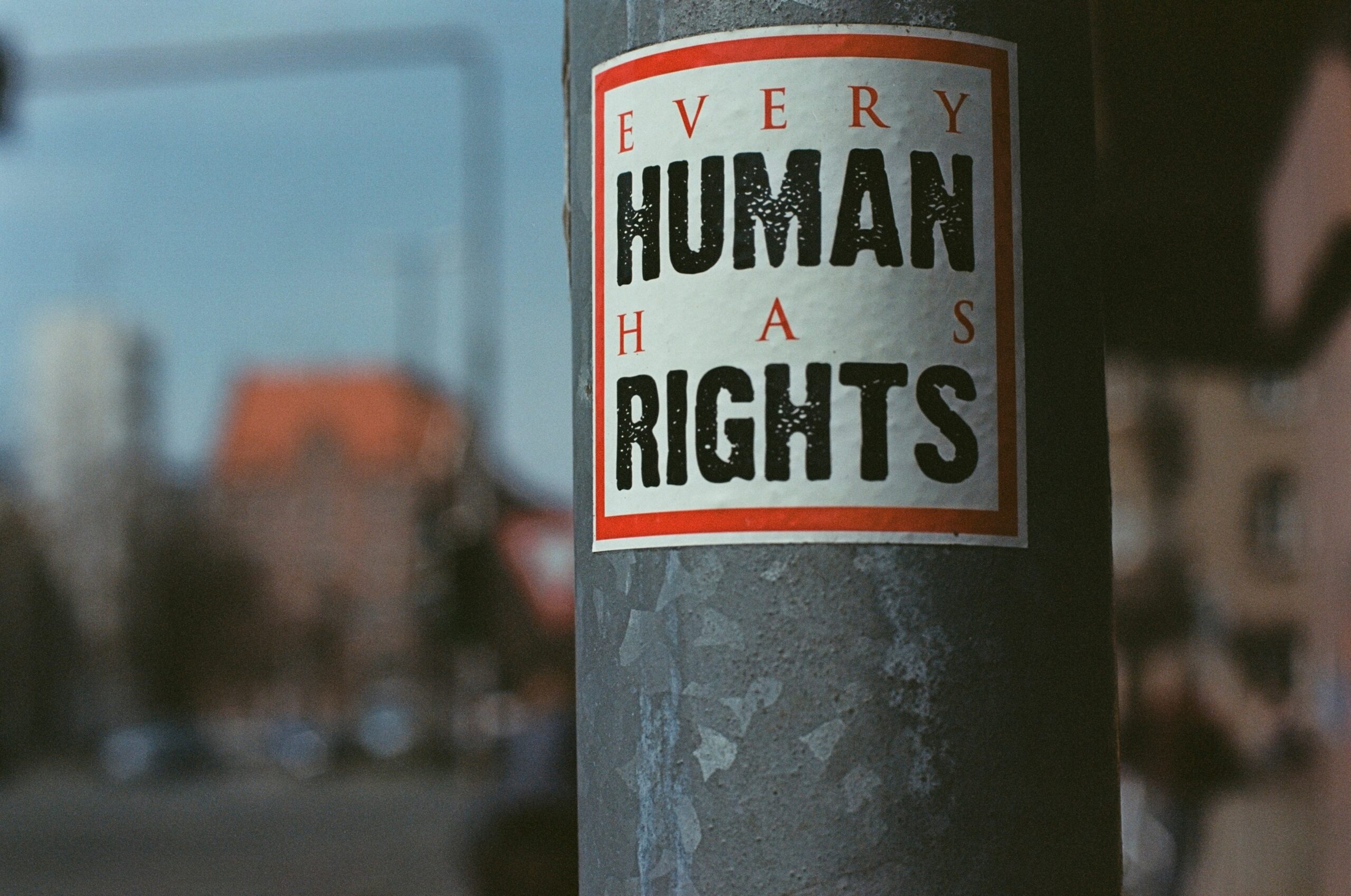 sticker reading "Every Human Has Rights" sticked to a street pole